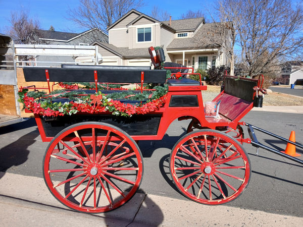 Red wagon with poinsettias and holiday greenery