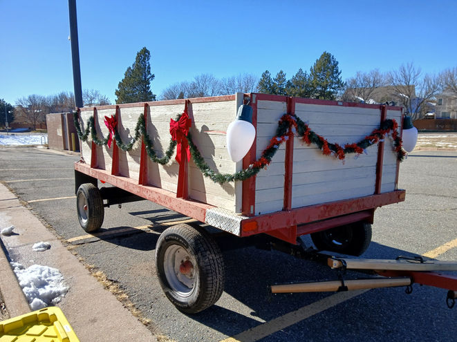 Farm wagon decorated with red and green garland